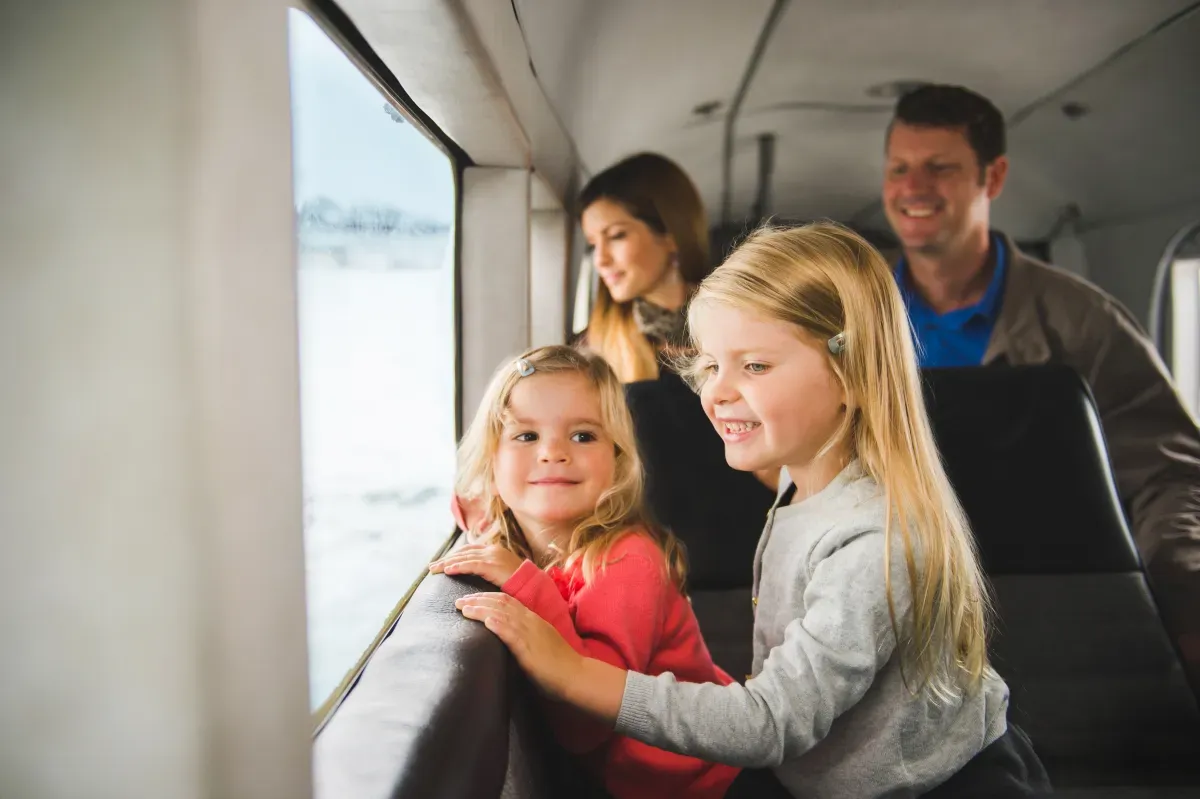 Girls looking out plane window.webp