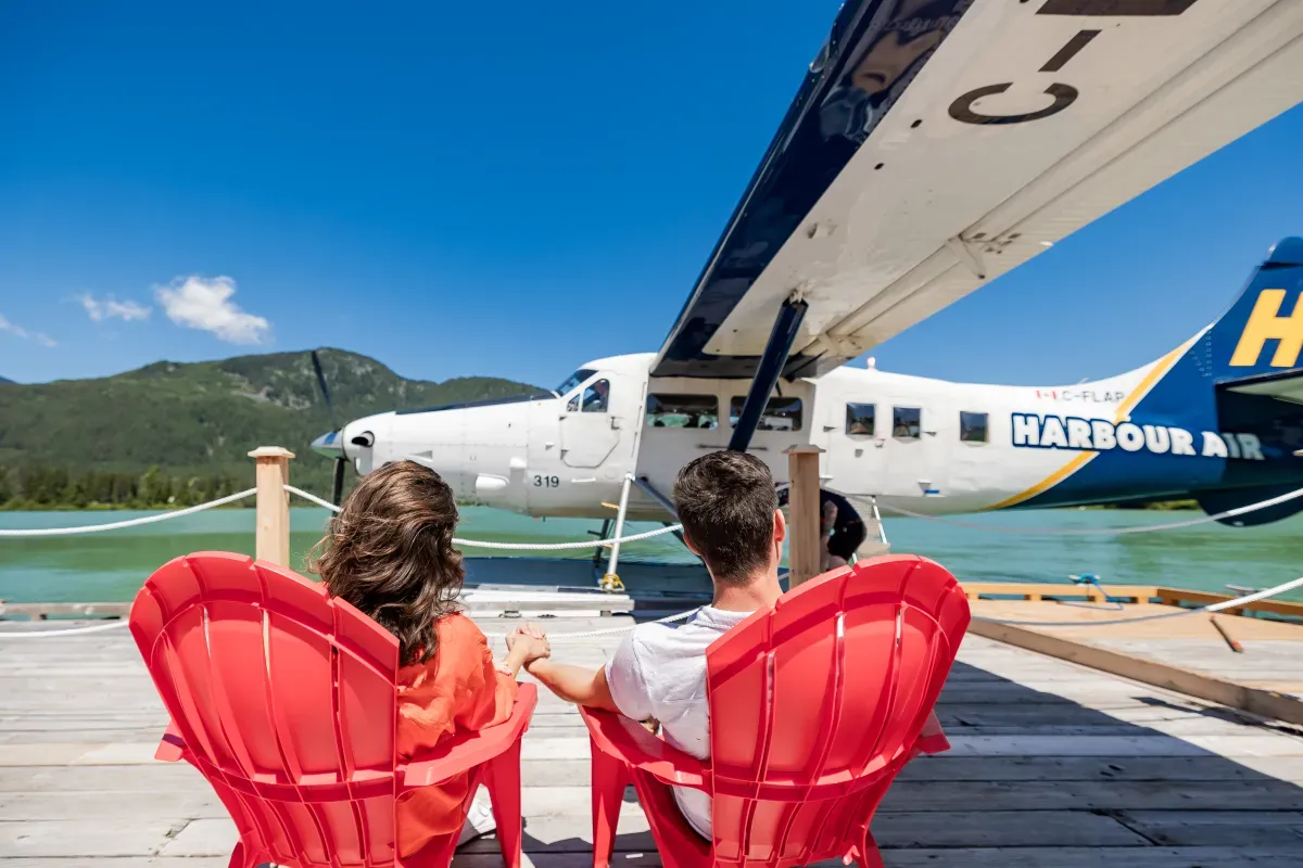 Passengers boarding a Harbour Air seaplane at Green  Lake dock in Whistler BC